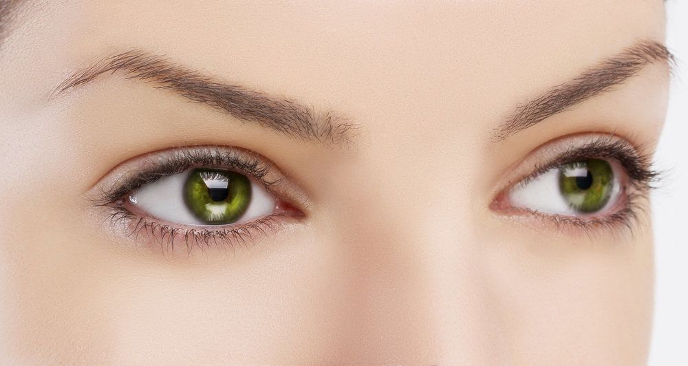 A close-up image of a woman with green eyes