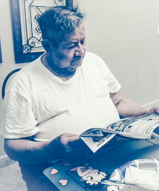 Older man reading newspaper
